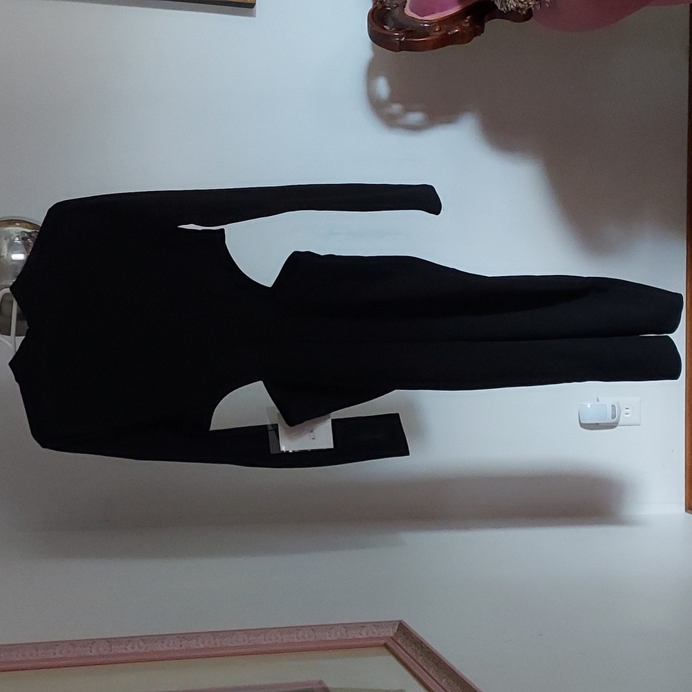 Black dress with long sleeves and hidden zipper in the back.